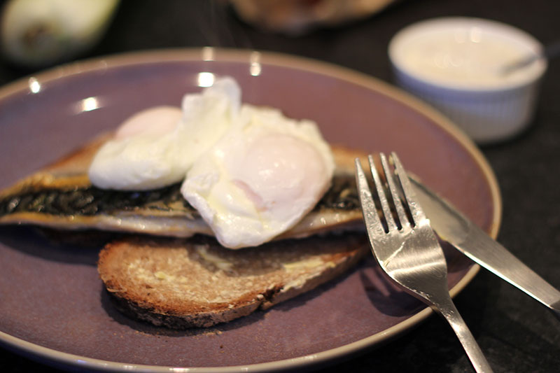 mackerel on rye bread with poached eggs and mustard yoghurt sauce