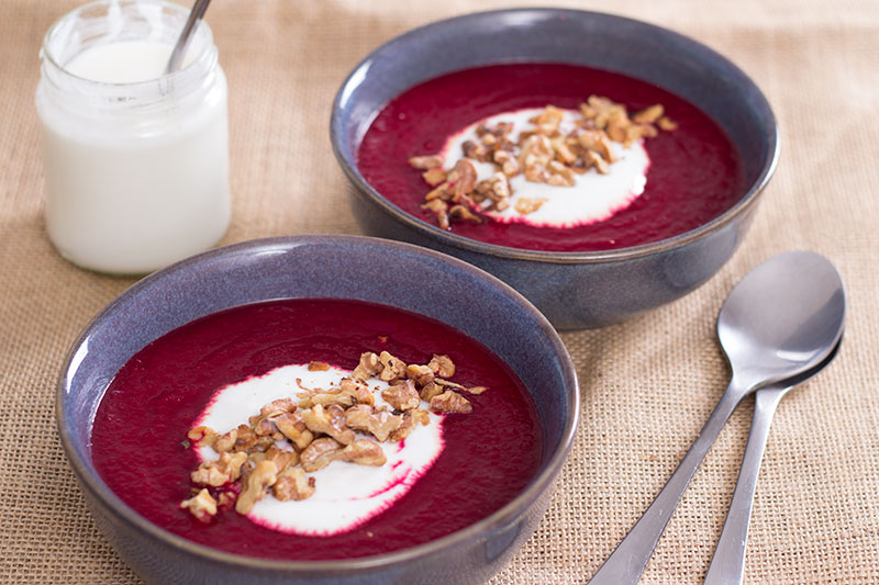 Beetroot apple and horseradish soup with walnuts and yoghurt ready to serve