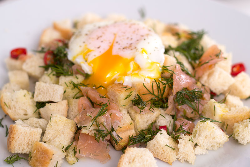 Brunch smoked salmon panzanella with poached egg