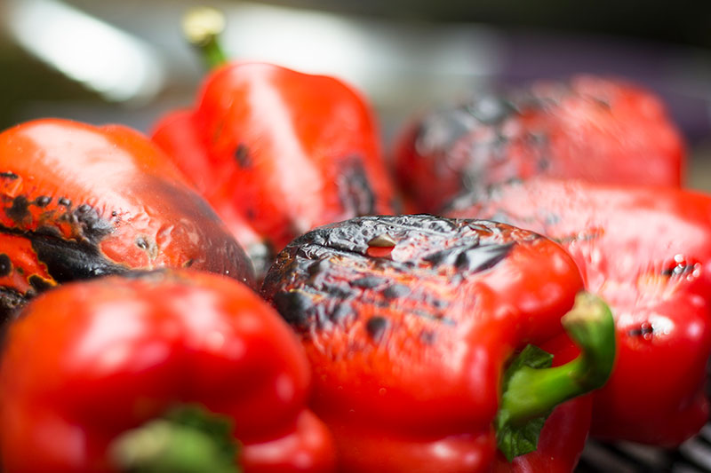 Charred red peppers on BBQ
