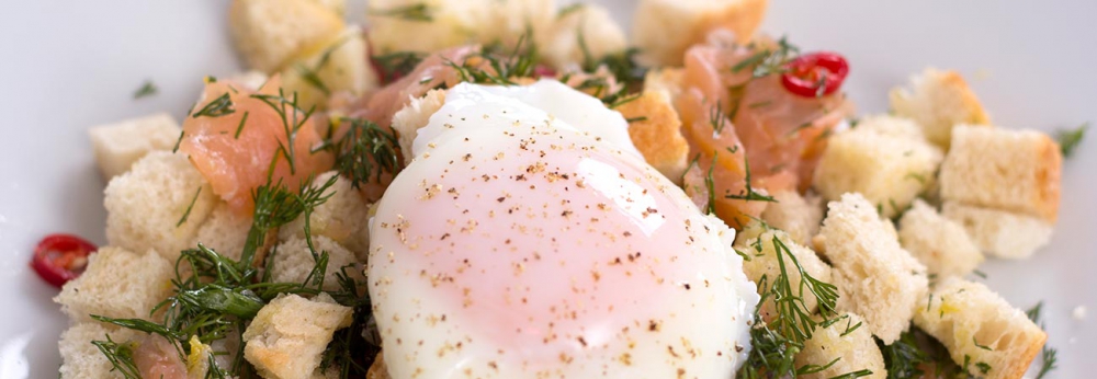 Brunch smoked salmon panzanella with poached egg