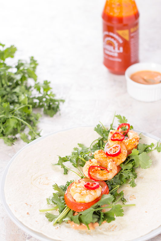 Aromatic prawn and coriander wrap on plate