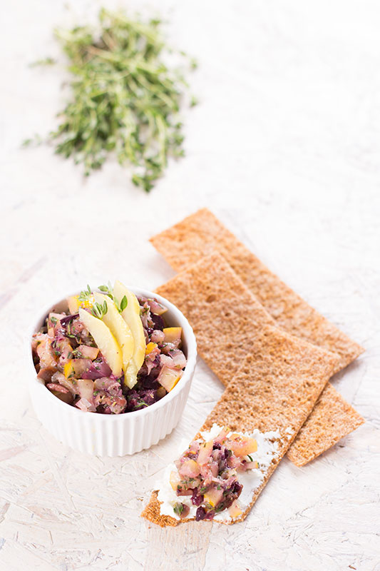 Preserved lemon tapenade on a cracker and in a bowl
