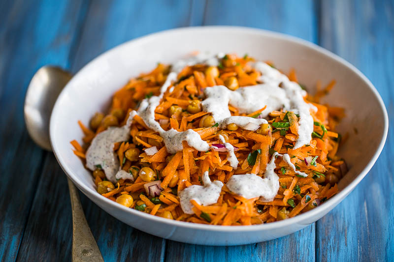 A quick, versatile and tasty vegetarian carrot and chickpea salad that you can add your own ingredients to for if you want to experiment. Made with carrots, chickpeas and parsley, it's a simple base that gets flavoured up with sumac, yoghurt, lemon juice and tahini so that there's no chance of your taste buds left wanting. It makes a great side dish or just fill your bowl and have it as a main course!